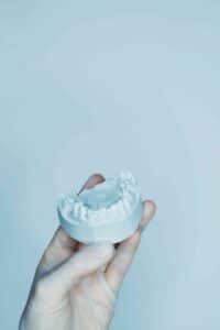 hand holding model teeth